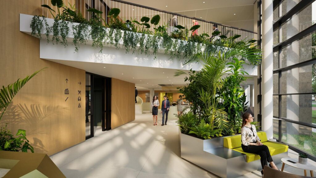 Modern office entrance hall with lush indoor plants, large windows, and people walking and sitting.